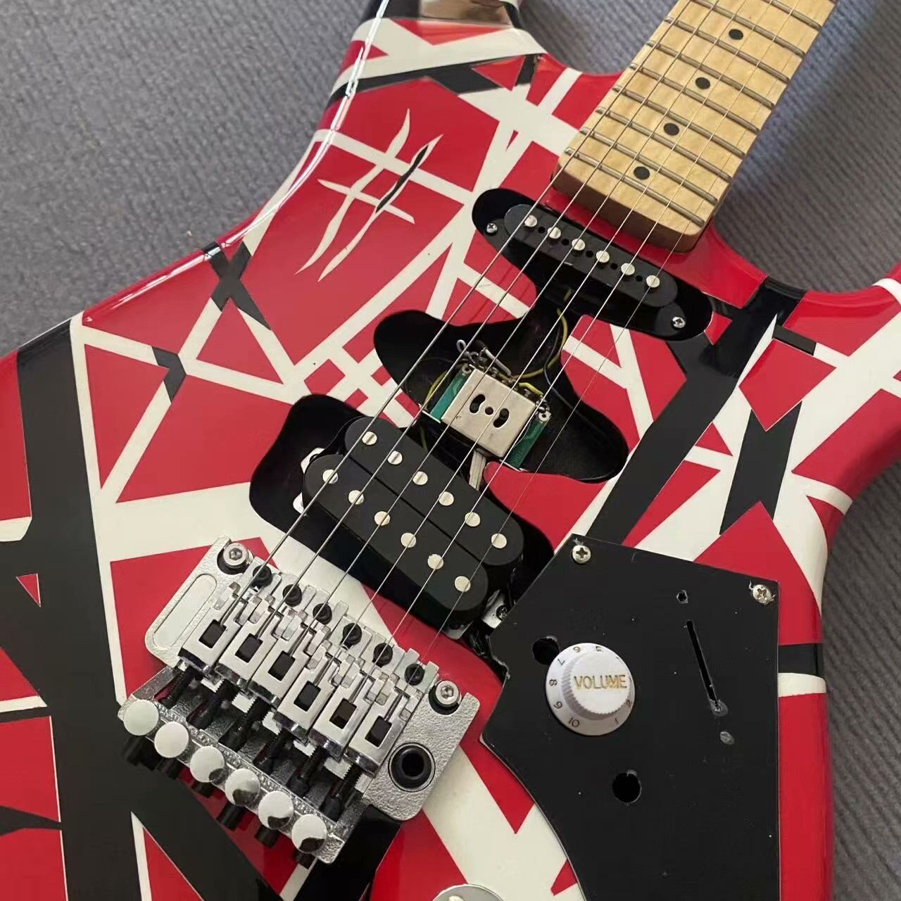 Bold Red Electric Guitar with Black/White Geometric Patterns, Maple Neck & Tremolo Bridge