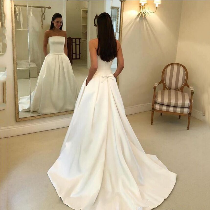 Custom Made Straplsess Satin A Line Wedding Dresses with Pockets Bow Court Train Ruffle Backless Bridal Gowns